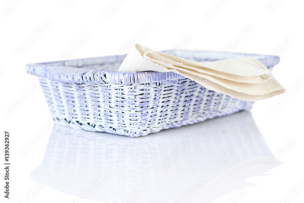 Obraz premium Wicker basket and napkin on white