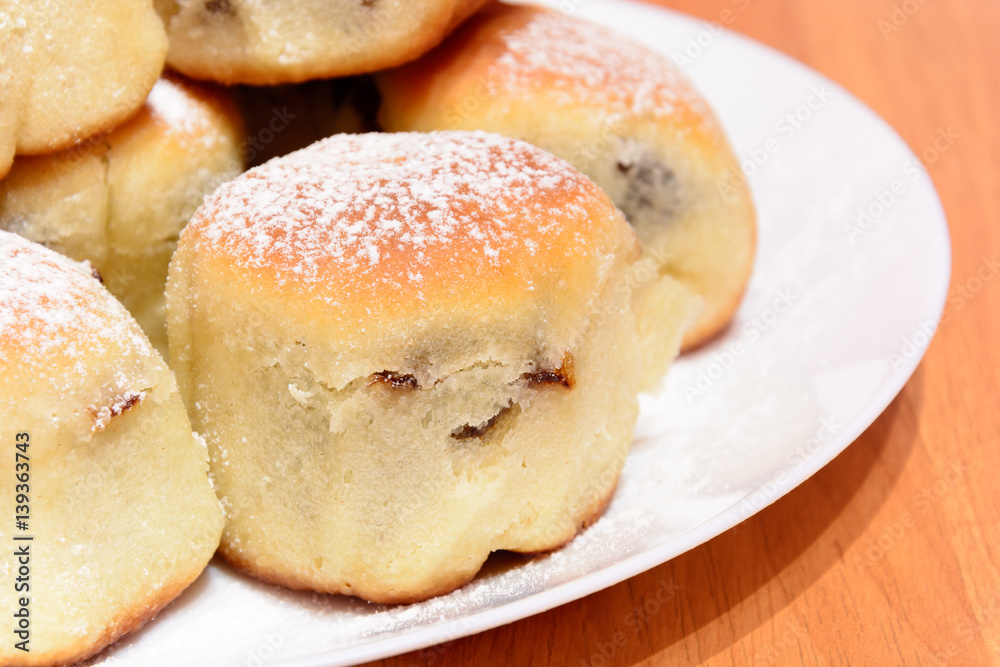Czech baked buns with jam and sugar. Baking cakes. Traditional Czech recipe for buns. Festive delicacies. Buns on a plate.