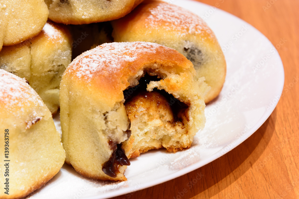 Czech baked buns with jam and sugar. Baking cakes. Traditional Czech recipe for buns. Festive delicacies. Buns on a plate.