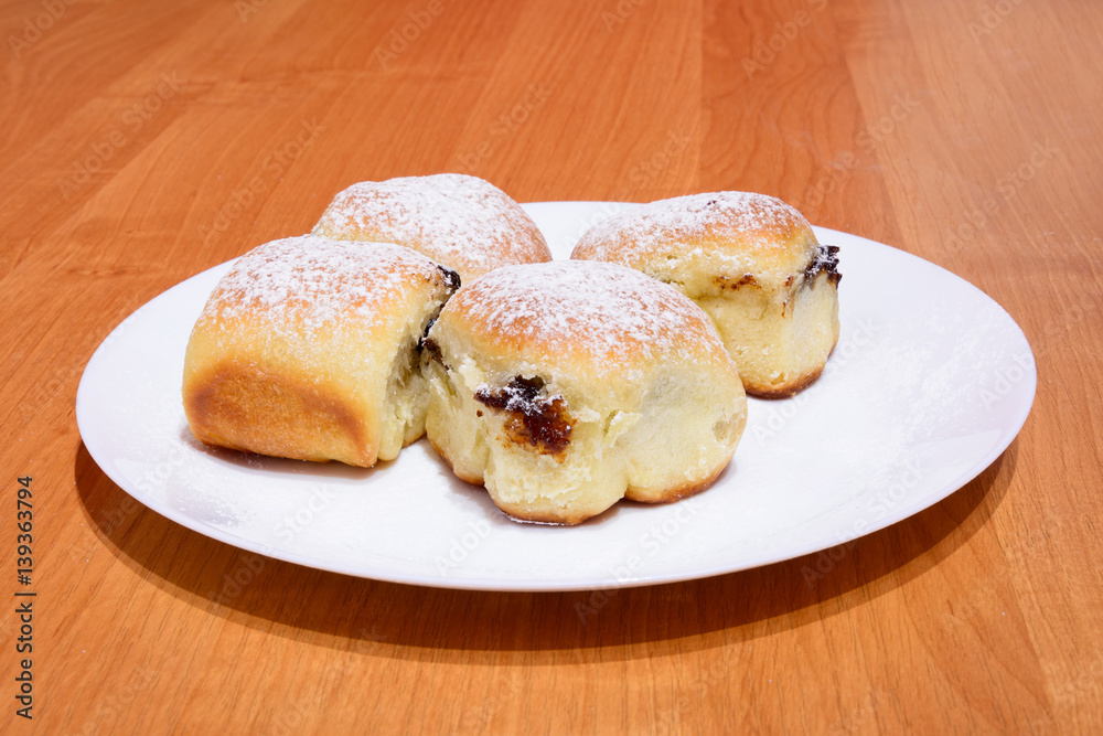 Czech baked buns with jam and sugar. Baking cakes. Traditional Czech recipe for buns. Festive delicacies. Buns on a plate. Czech baked buns with jam and sugar. Baking cakes. Traditional Czech recipe for buns. Festive delicacies. Buns on a plate.