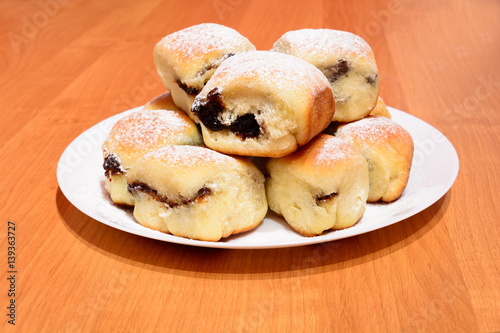 Czech baked buns with jam and sugar. Baking cakes. Traditional Czech recipe for buns. Festive delicacies. Buns on a plate.