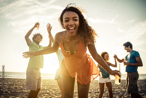 Group of friends having fun on the seashore © oneinchpunch