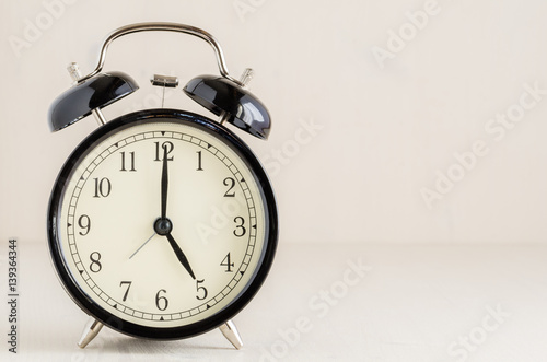 Vintsge Alarm Clock on a Wooden Background photo