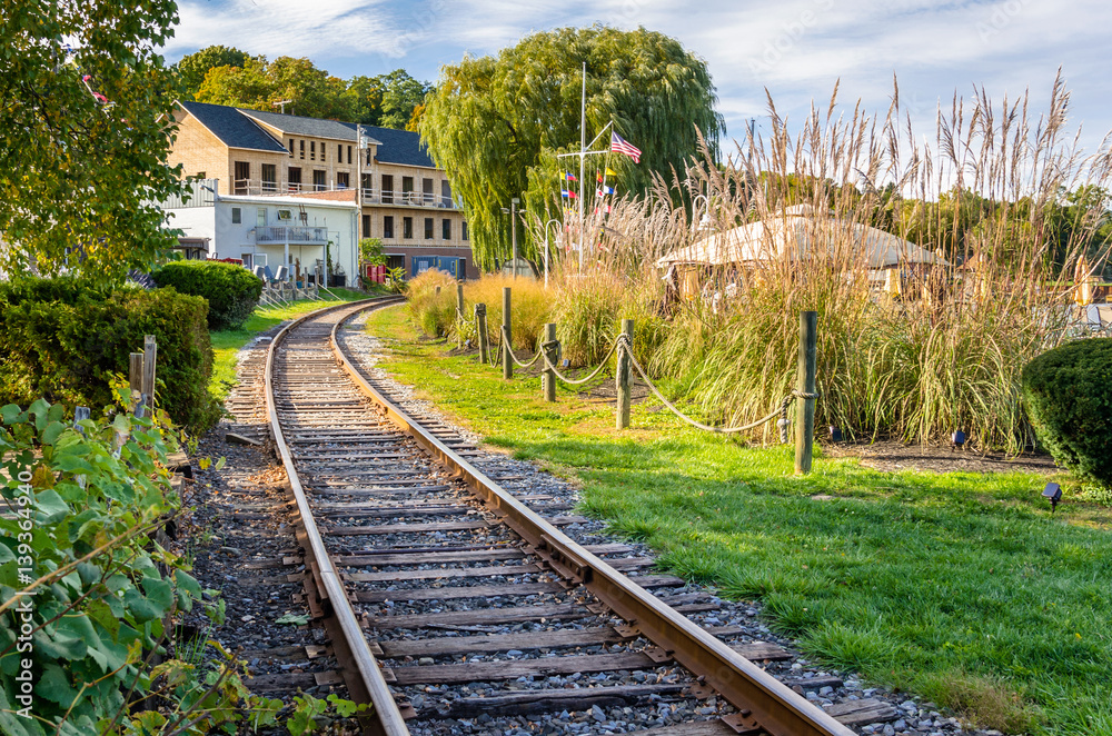 Railway Track Running Through a Village on a Sunny Autumn Day