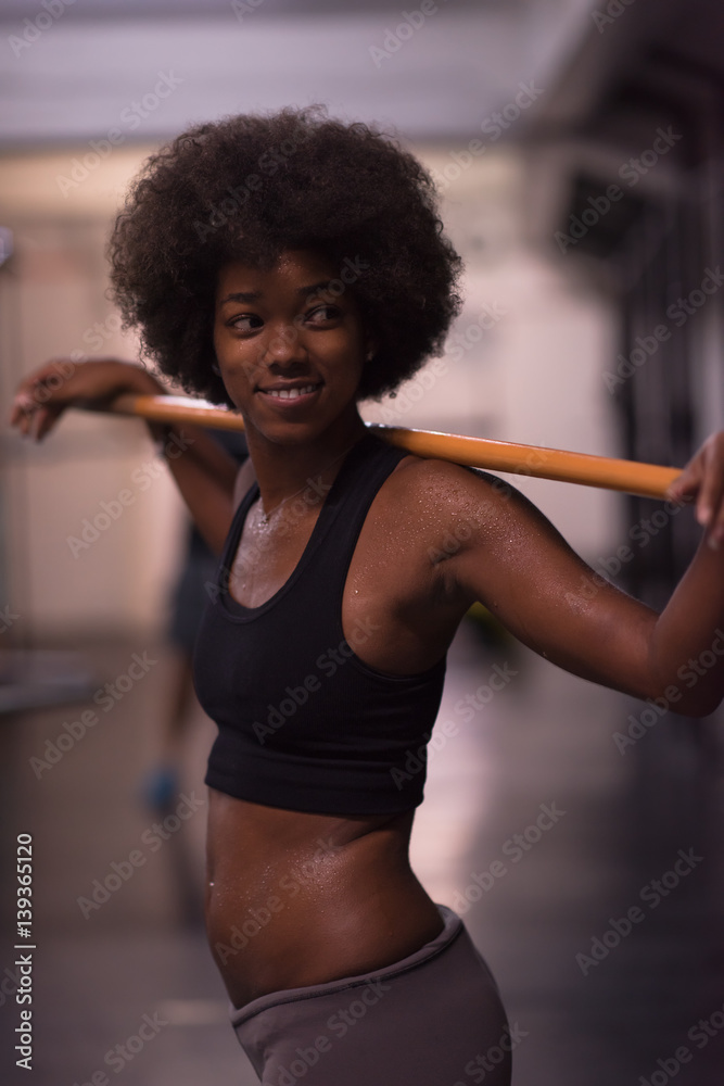 black woman lifting empty bar