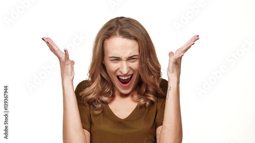 Angry Caucasian middle-aged female with long brown hair screaming on white background