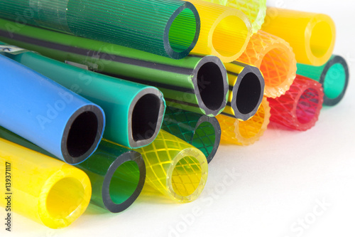 colorful plastic gardening hoses on white background