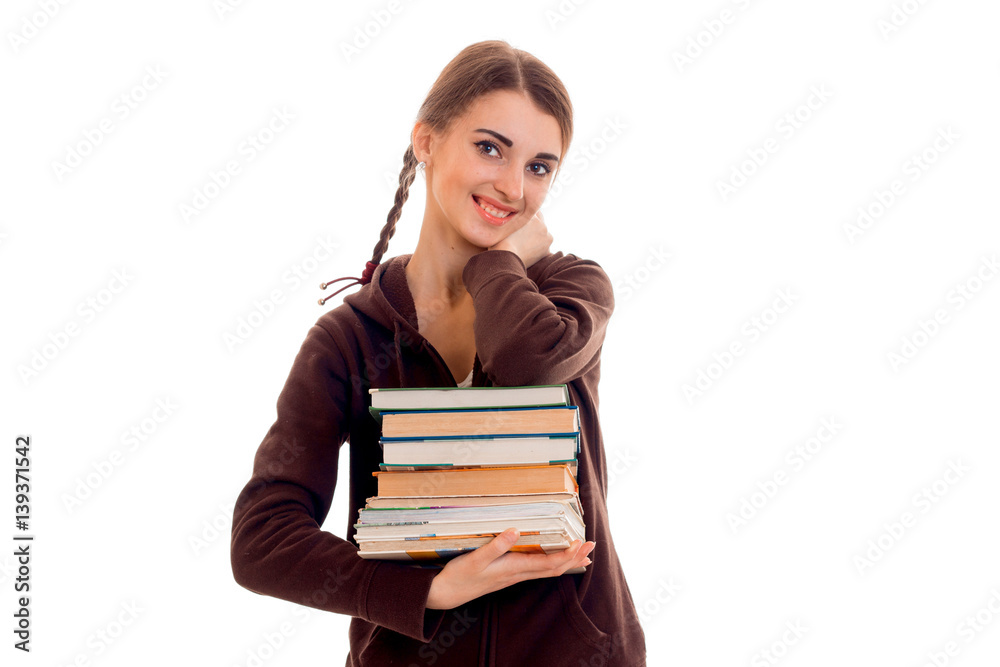 cute teen girl with pigtails smiling and holding a book in their hands cute teen girl with pigtails smiling and holding a book in their hands