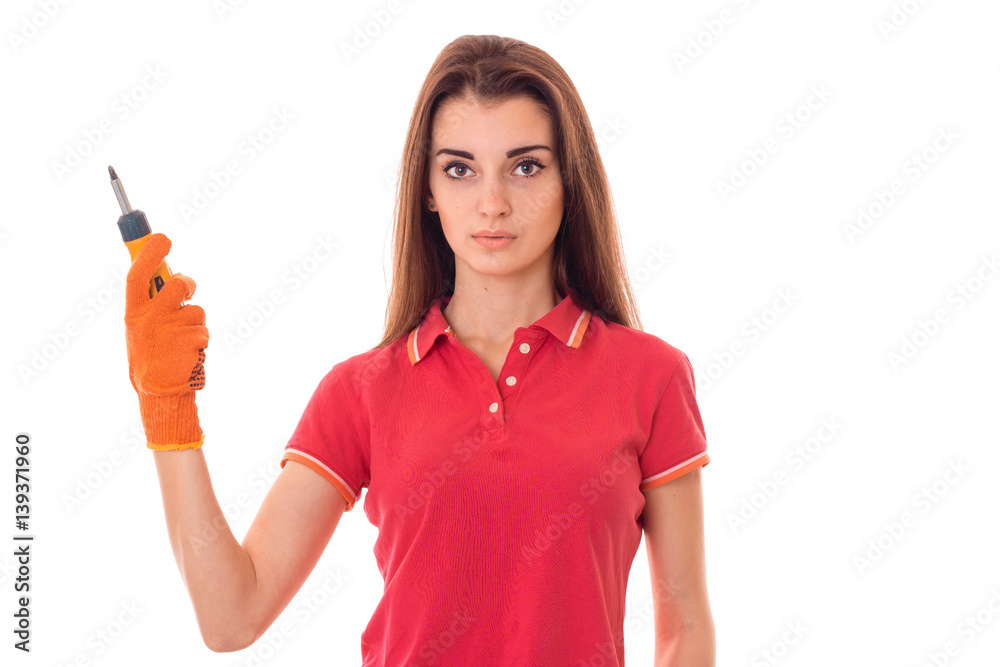 young girl holding a tool for repair of apartments with a serious face