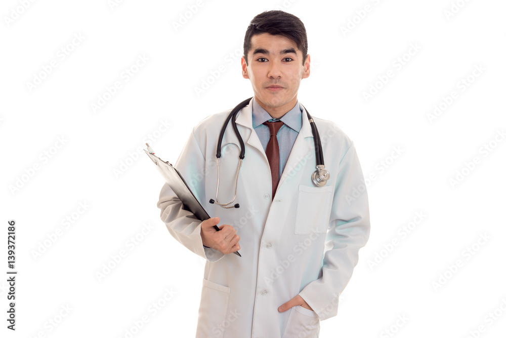 a young doctor in a white lab coat with a stethoscope holding a Tablet for securities a young doctor in a white lab coat with a stethoscope holding a Tablet for securities