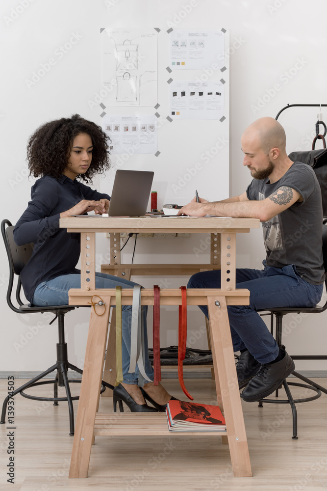 Young designers are working at table in studio Young designers are working at table in studio