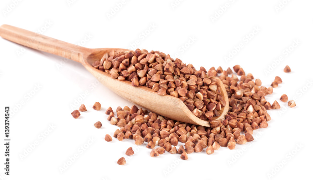 buckwheat in the wooden scoop isolated on white background