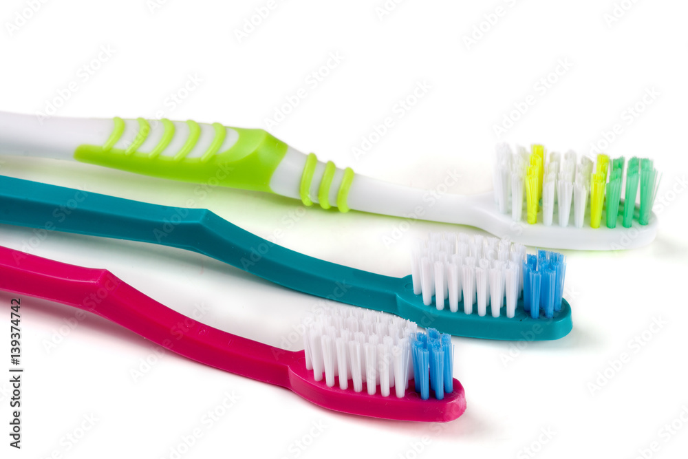 Three toothbrushes isolated on a white background closeup Three toothbrushes isolated on a white background closeup