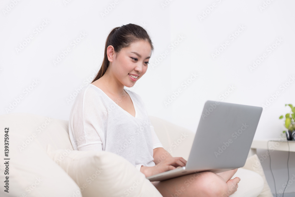 young pretty woman using laptop on sofa young pretty woman using laptop on sofa