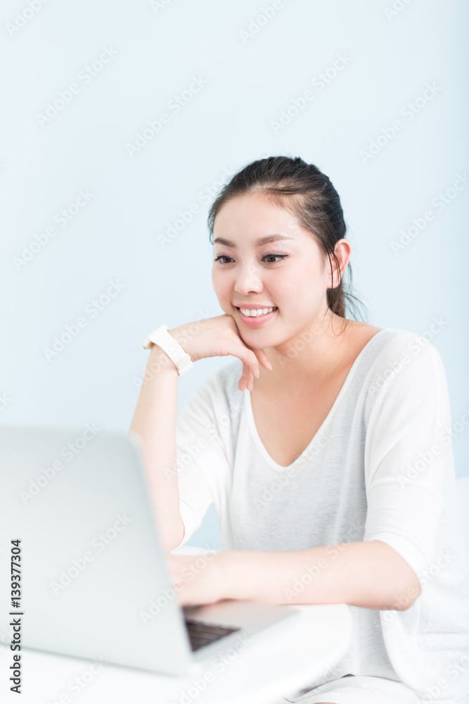 young pretty woman using laptop in office