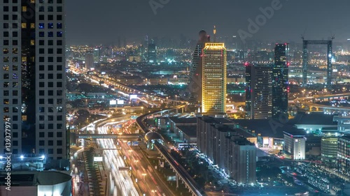 Wallpaper Mural Scenic Dubai downtown architecture night timelapse. Top view over Sheikh Zayed road with illuminated skyscrapers and traffic. Torontodigital.ca