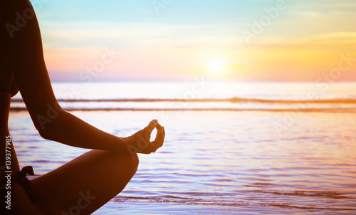 yoga or meditation concept background, silhouette on the beach