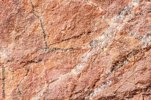 Stone, rock with brown tint texture, selective focus. For background , backdrop, substrate, composition use.