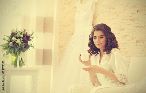 Beautiful bride drinking co...