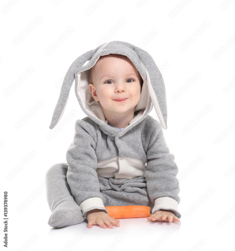Cute little baby in bunny costume with carrot on white background Cute little baby in bunny costume with carrot on white background