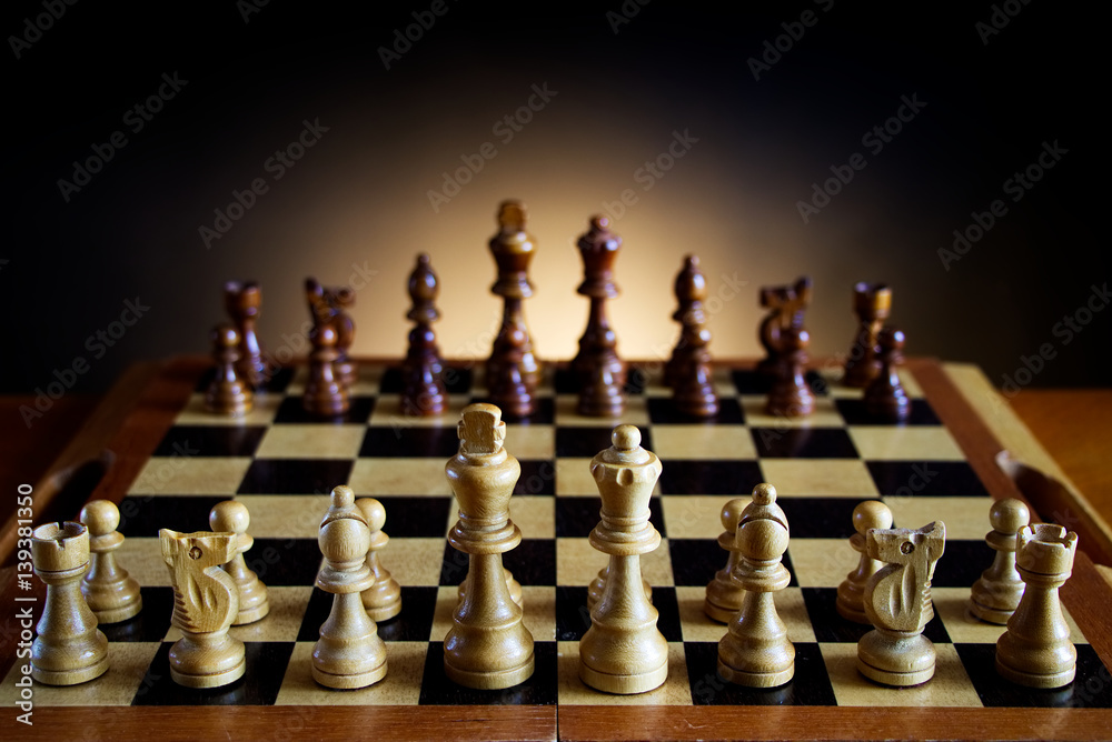 ready for a game of chess, wooden chessboard on a table, dark gradient background ready for a game of chess, wooden chessboard on a table, dark gradient background