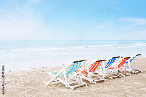 empty deck chairs on the beach, crisis in tourism or family holidays background