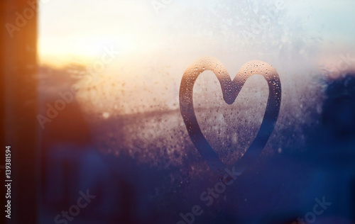 valentines day card, love and kindness concept, heart painted on frozen glass window photo