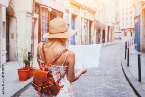 Photography woman tourist looking at the map on the street of european city, travel to Europ