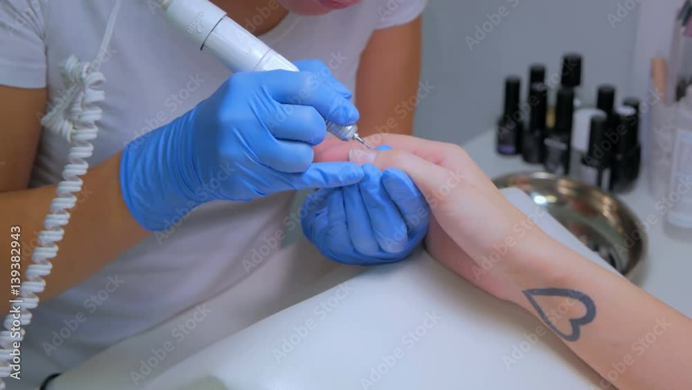 Manicure nail care in a beauty salon. Beauty and nail care concept Manicure nail care in a beauty salon. Beauty and nail care concept