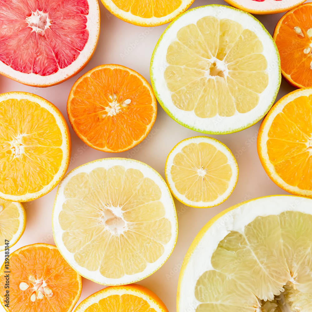 Citrus fruits pattern made of lemon, orange, grapefruit, sweetie and pomelo isolated on white background. Flat lay, top view. Fruit background