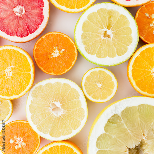 Citrus fruits pattern made of lemon, orange, grapefruit, sweetie and pomelo isolated on white background. Flat lay, top view. Fruit background