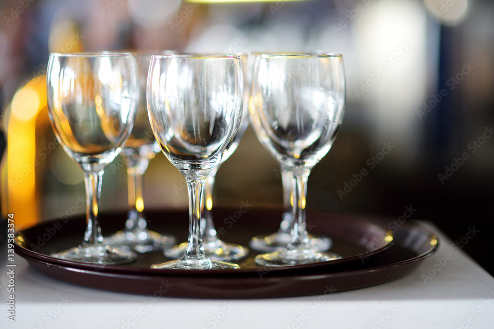 Lots of wine glasses during some festive event Lots of wine glasses during some festive event