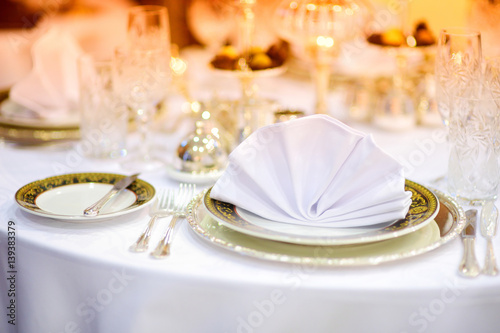 Beautiful table setting with crockery and flowers for a party, wedding reception or other festive event