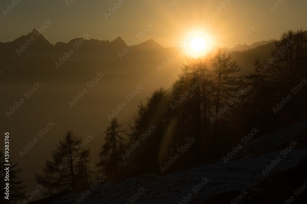 sunset in the foggy mountains 