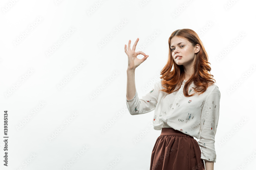positive gesture, a woman shows a connected thumb and index finger positive gesture, a woman shows a connected thumb and index finger