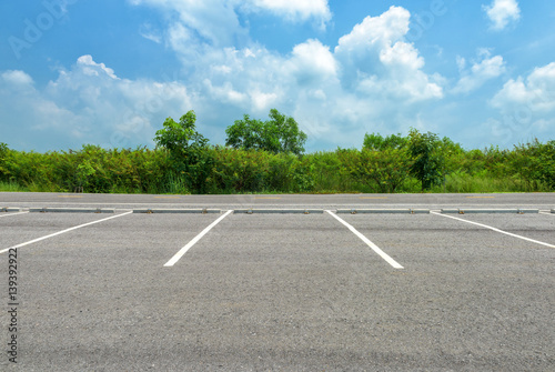 Empty parking lot on blue sky background