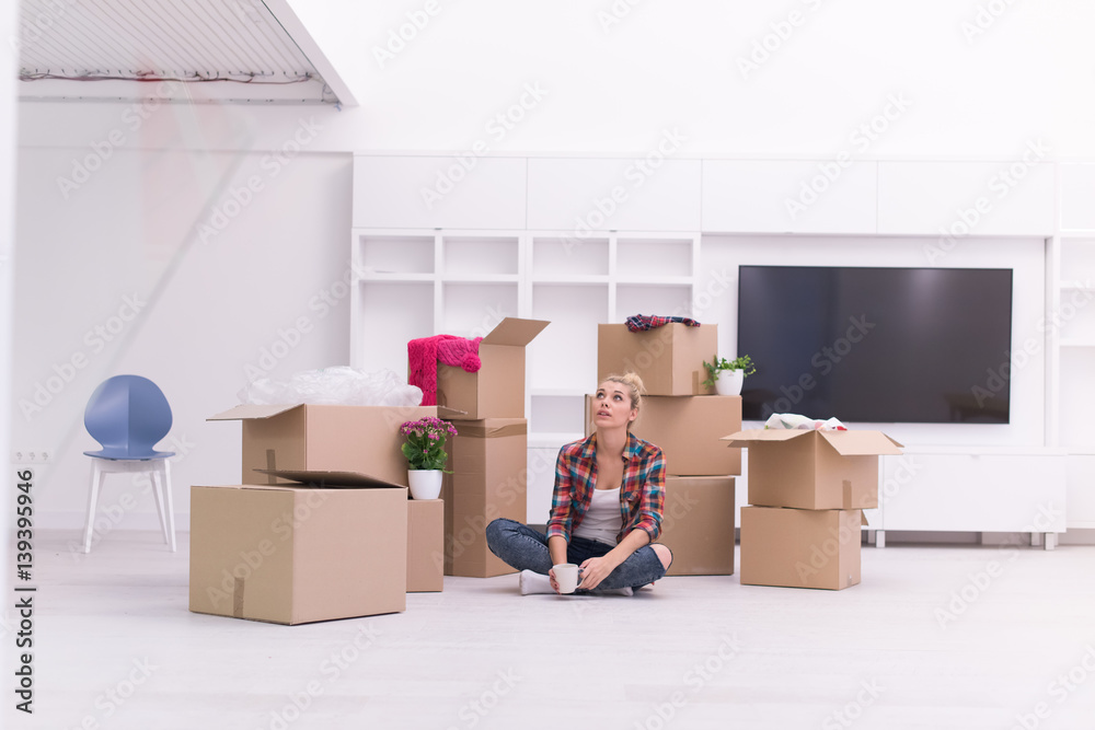 woman with many cardboard boxes sitting on floor woman with many cardboard boxes sitting on floor