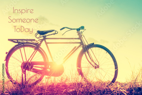 beautiful landscape image with Bicycle at sunset in vintage tone style