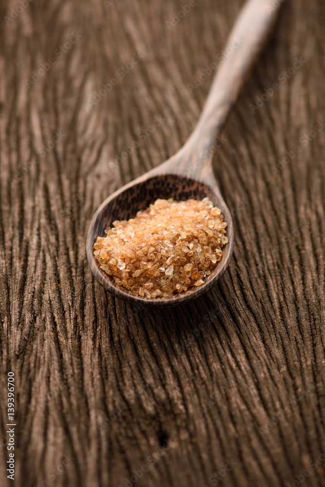 Raw Organic Cane Sugar in a wooden spoon Raw Organic Cane Sugar in a wooden spoon