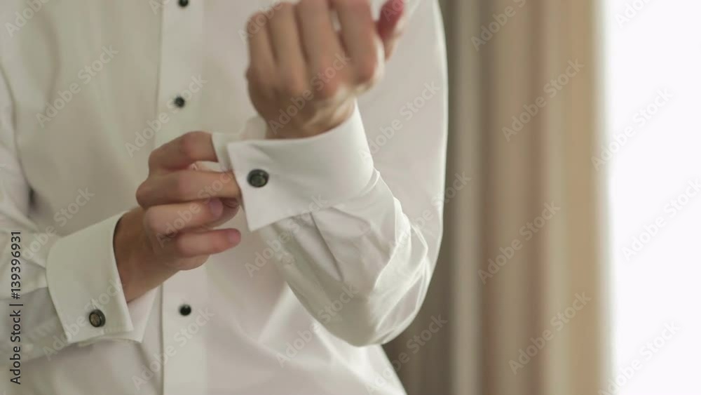 Closeup Of Man Putting In Cufflinks During Wedding Closeup Of Man Putting In Cufflinks During Wedding