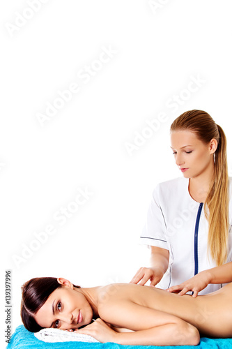 Woman having massage of body in the spa salon. Beauty treatment concept.