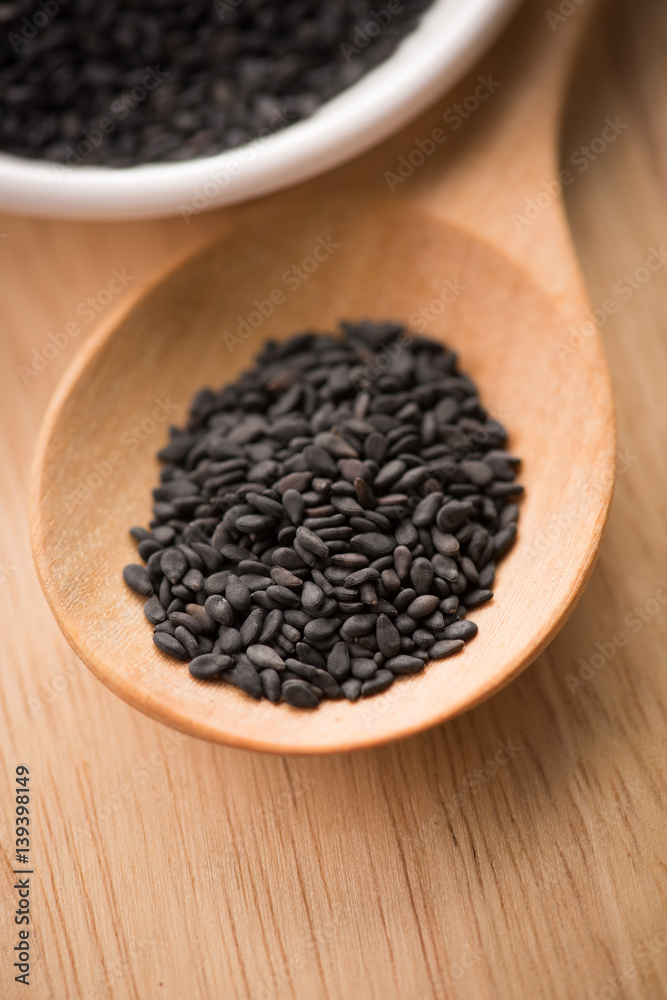 black Sesame close up shot on wood background black Sesame close up shot on wood background
