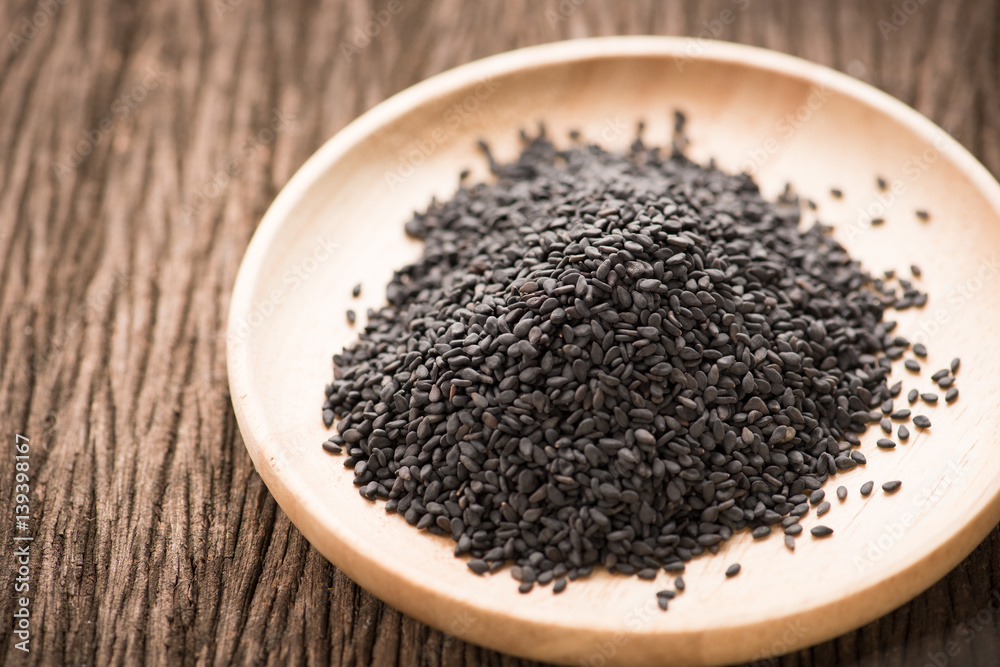 black Sesame close up shot on wood background black Sesame close up shot on wood background