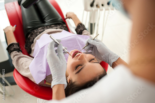 Girl treats the teeth in dentistry © fotofrol