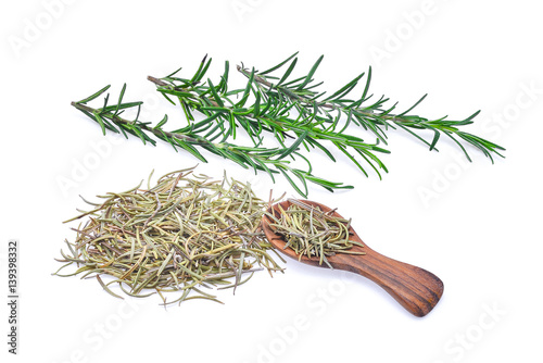 fresh and dried rosemary in wooden spoon isolated on white background.