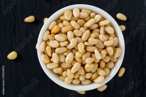 pine nuts on dark background photo