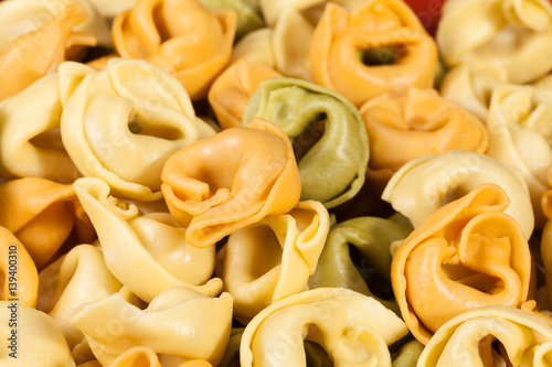 Background of colored tortellini, ring-shaped pasta