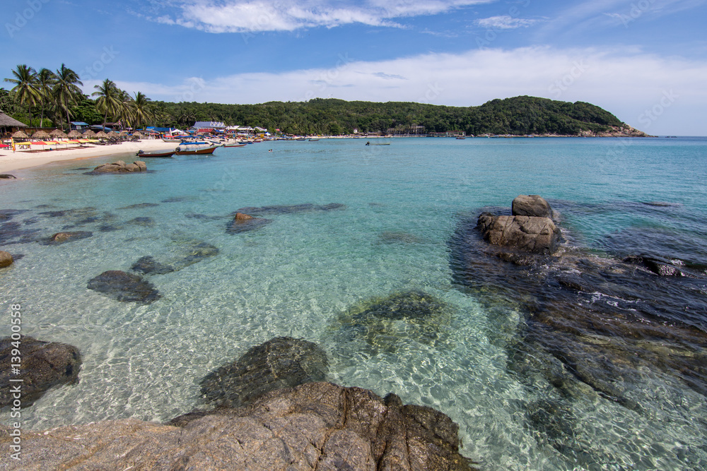 The crystal clear waters of Pulau Perhentian Kecil with the beach and head lands in the back ground.