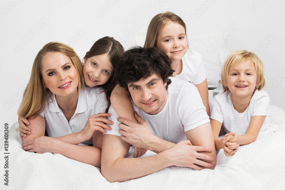 Smiling family in bed Smiling family in bed