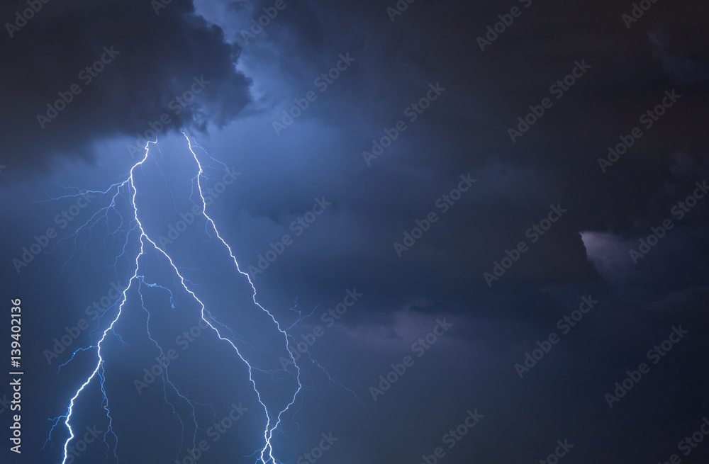 a flash of lightning and the clouds during a night storm a flash of lightning and the clouds during a night storm